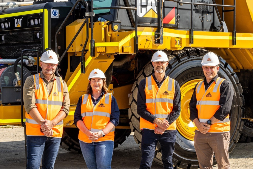 SEE Group Board of Directors standing in a group with hard hats - Urban Development